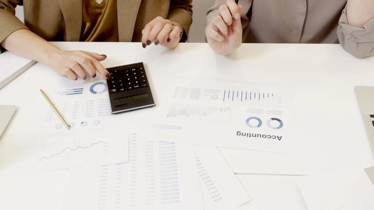Australian bookkeeper and small business owner reviewing accounting data on a laptop