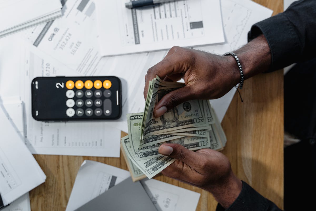 Australian small business owner reviewing invoices and tracking bookkeeping costs on a desk
