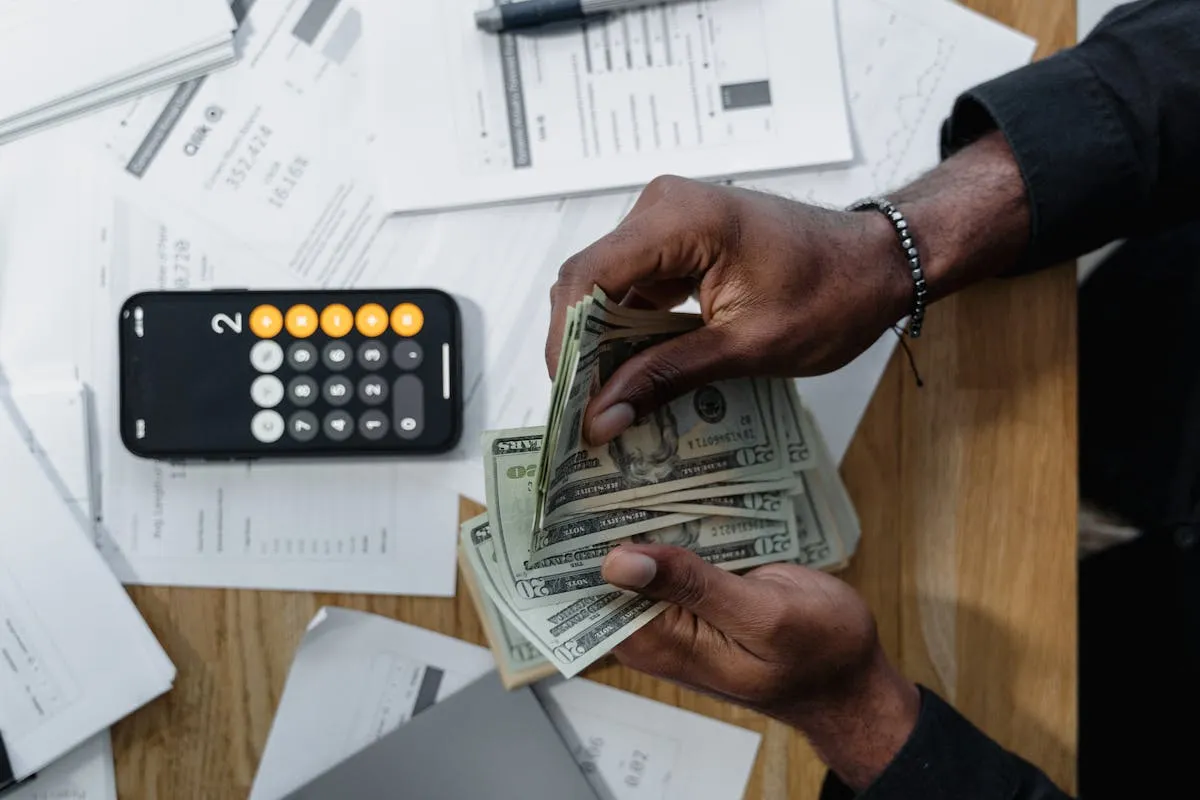 Australian small business owner reviewing invoices and tracking bookkeeping costs on a desk